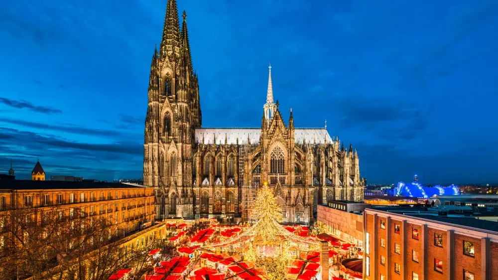 german christmas market aerial shot with stalls and church
